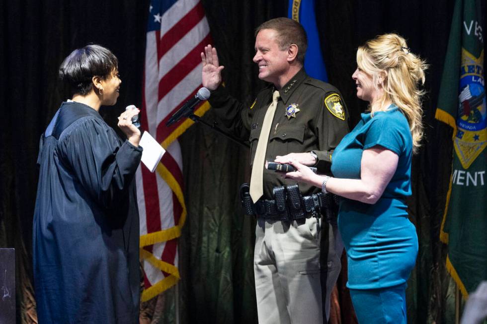 Sheriff Kevin McMahill raises his arm as he is sworn in by Judge Tierra Jones as LVMPD Sheriff ...