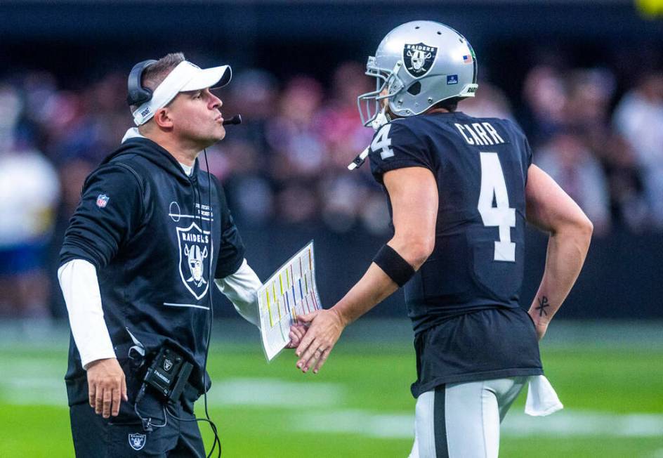 Raiders Head Coach Josh McDaniels congratulates quarterback Derek Carr (4) after a score during ...