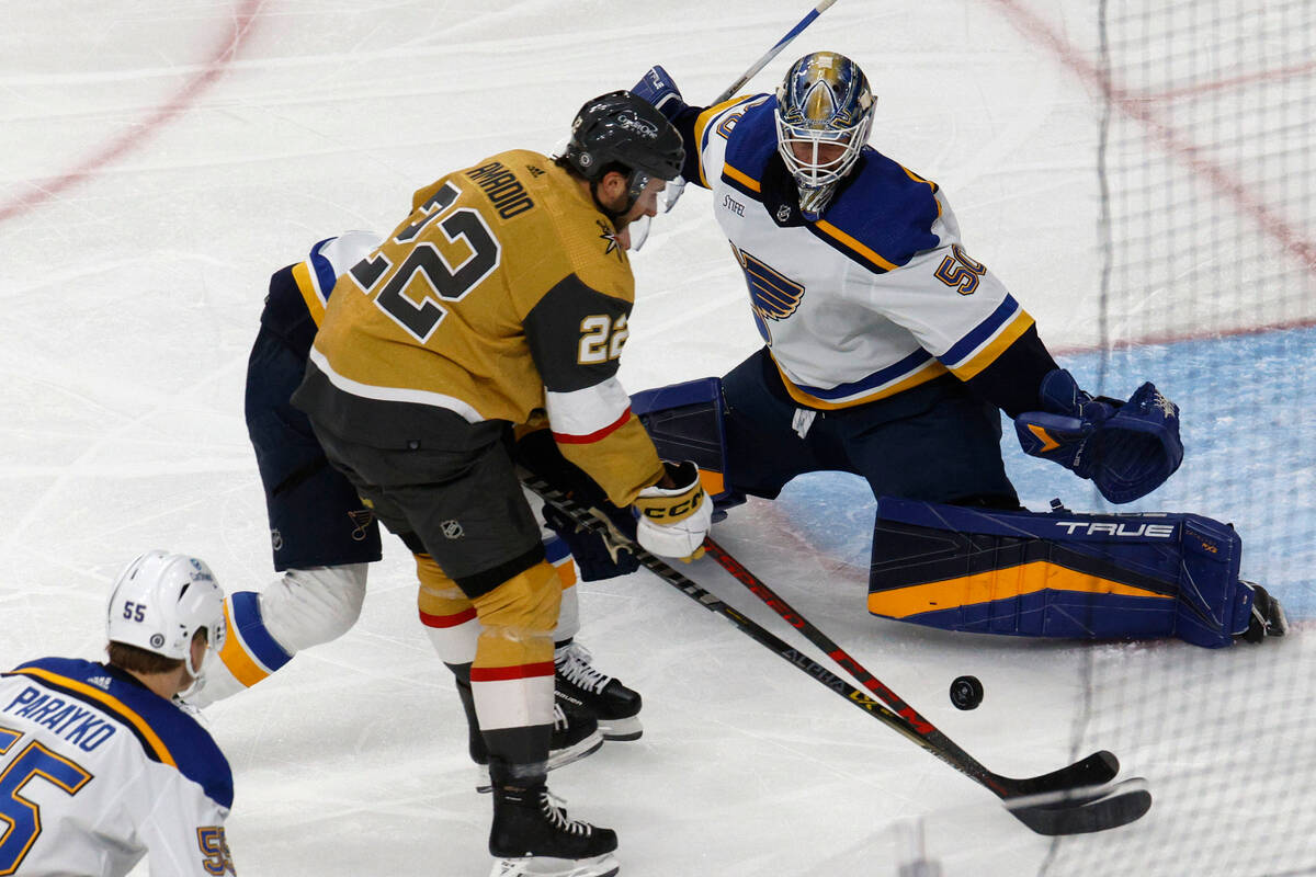 Golden Knights center Michael Amadio (22) tries to shoot against St. Louis Blues goaltender Jor ...