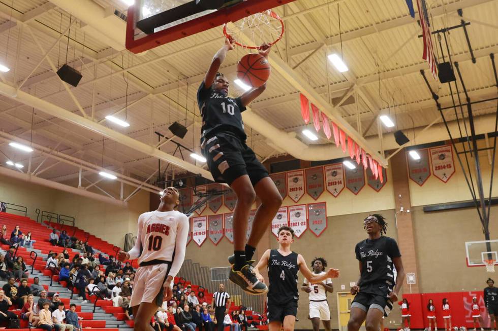 Shadow Ridge's Jalen Butler (10) dunks the ball as Arbor View's Tremmell Darden (10) looks on d ...