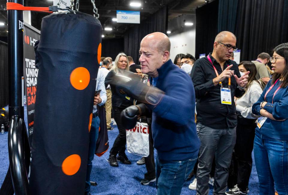 Steve Greenberg hits the I-Percut smart punching bag cover during the CES Unveiled media days e ...
