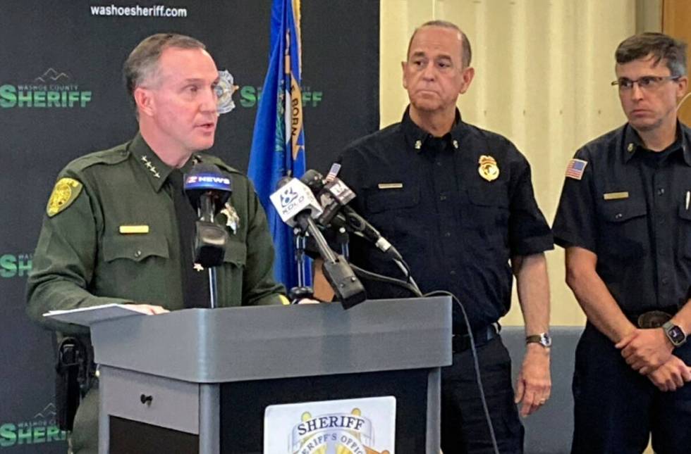 Washoe County Sheriff Darin Balaam, left, answers a reporter's question as fire officials look ...