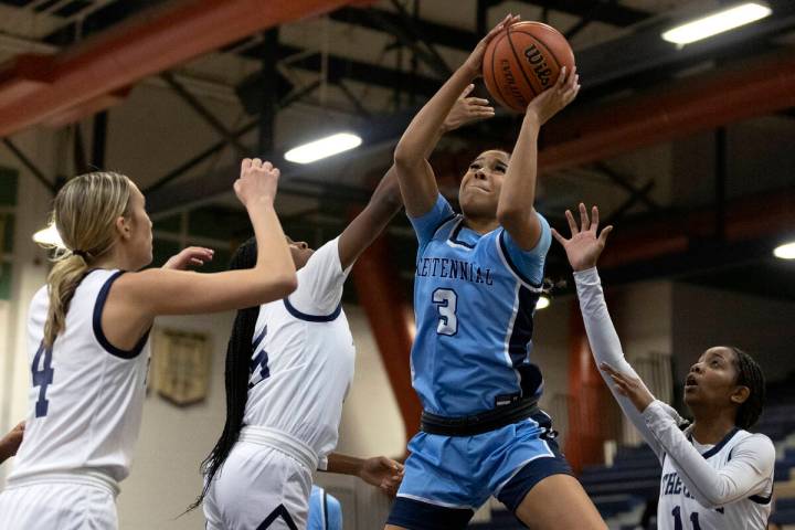 Centennial’s Charlece Ohiaeri (3) shoots against Shadow Ridge players Kelly Megown (4), ...