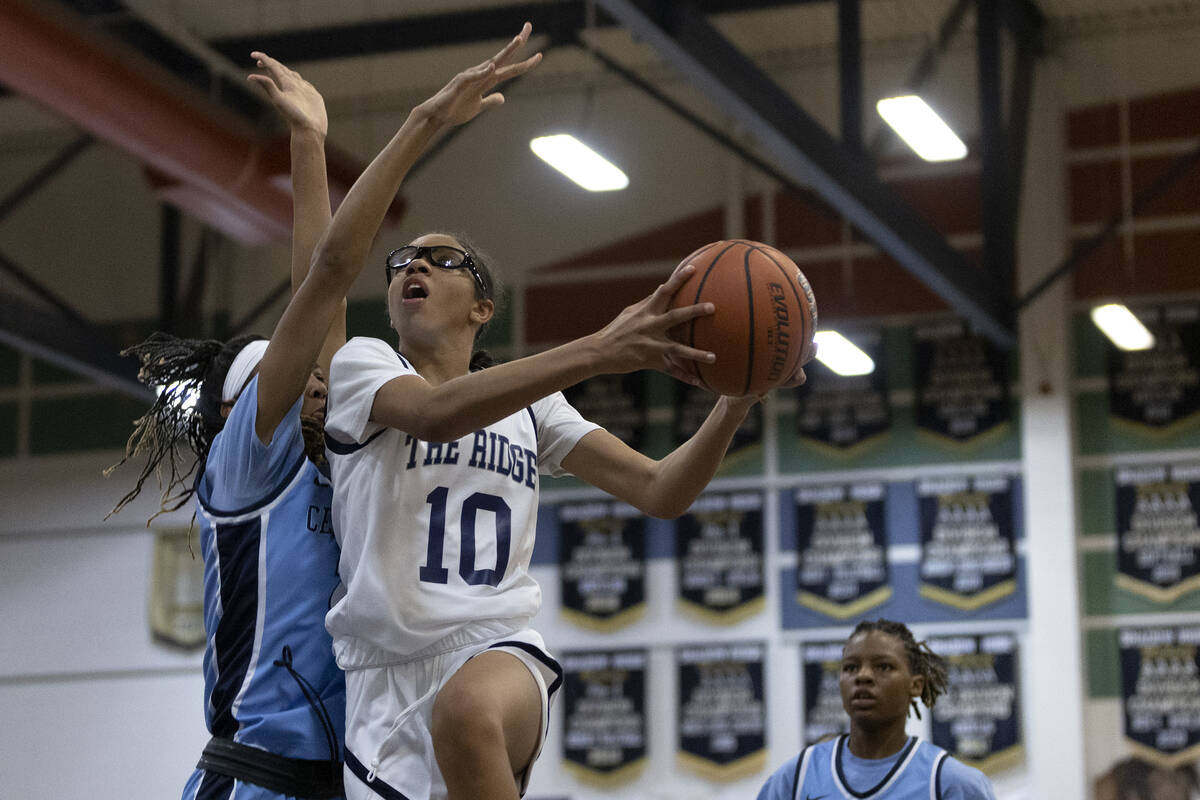 Shadow Ridge’s Jaslyn Jefferson (10) shoots against Centennial’s Cici Ajomale, left, during ...