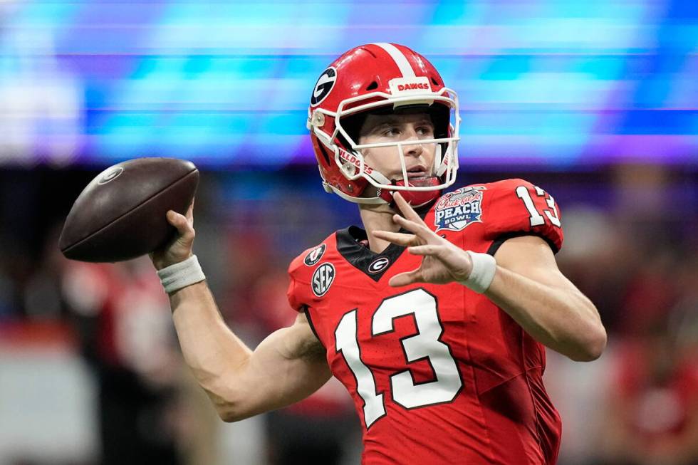 Georgia quarterback Stetson Bennett (13) warms up before the Peach Bowl NCAA college football s ...