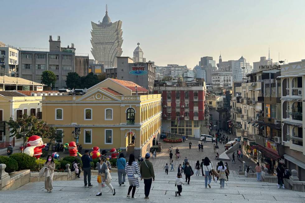 Tourists enjoy unusual tranquility at the historic site Ruins of St. Paul’s in Macao on Dec. ...