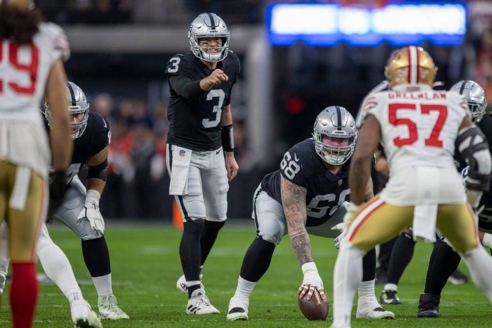 Raiders quarterback Jarrett Stidham (3) audibles at the line of scrimmage with Raiders center A ...