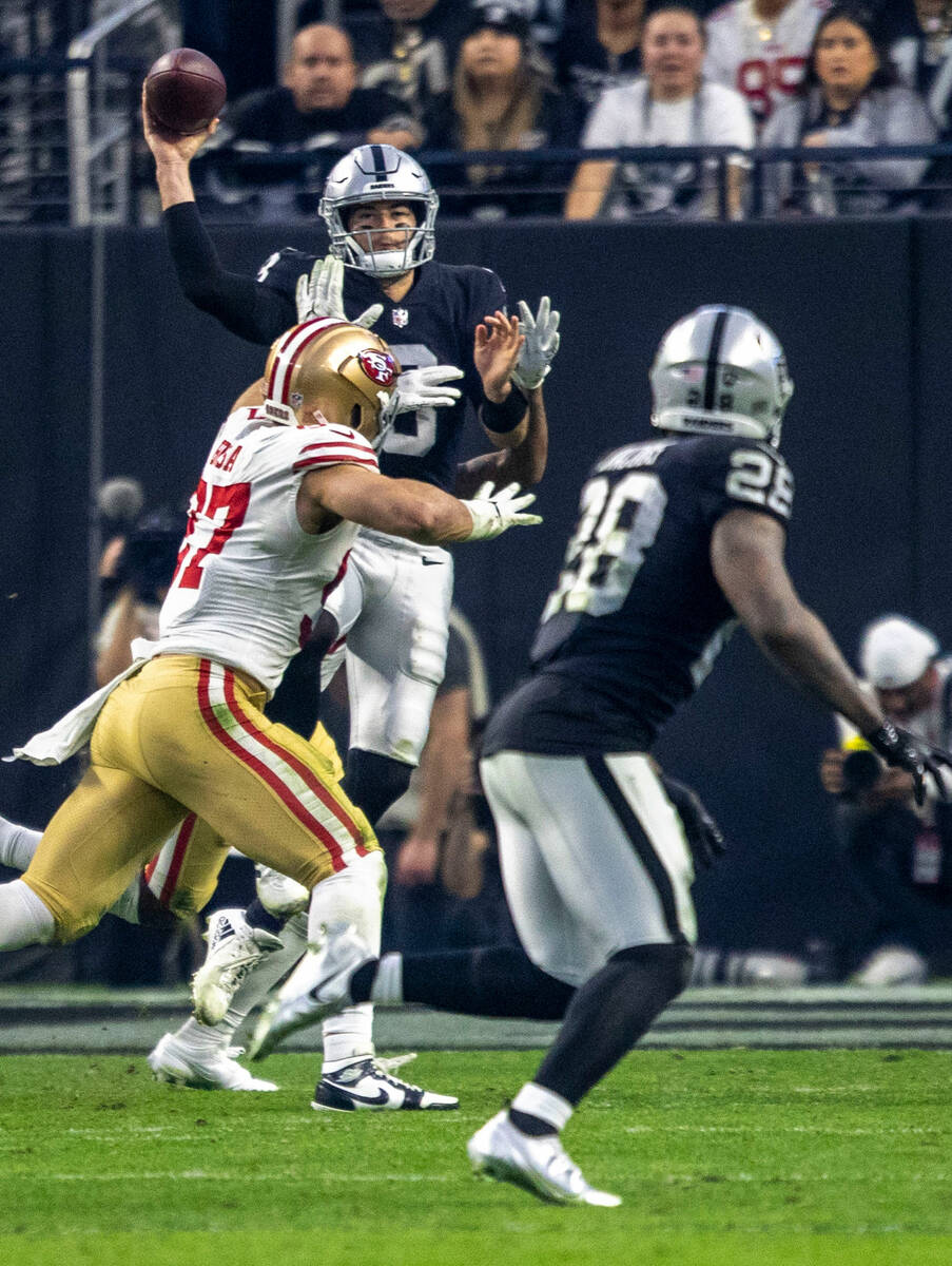 Raiders quarterback Jarrett Stidham (3) throws under pressure from San Francisco 49ers defensiv ...