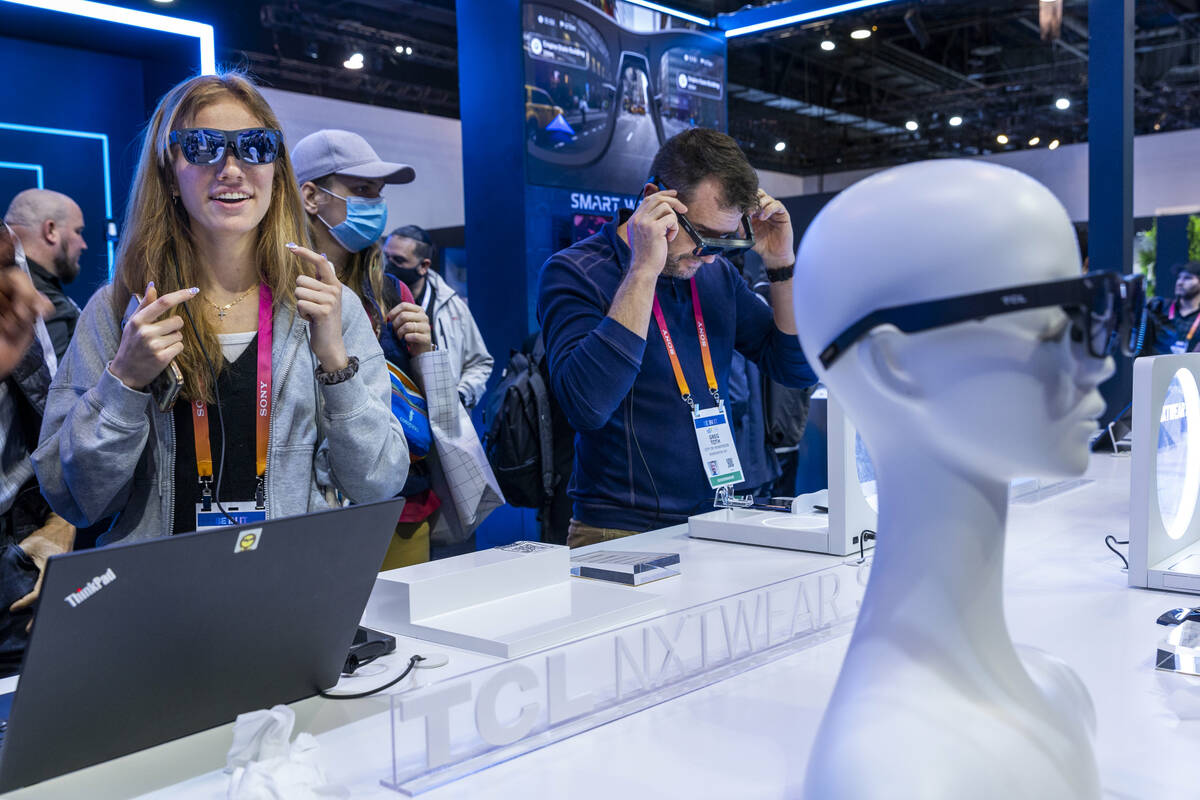 Caroline Abeyta tries on a pair of TCL Nextwear smart sunglasses during the opening day of CES ...