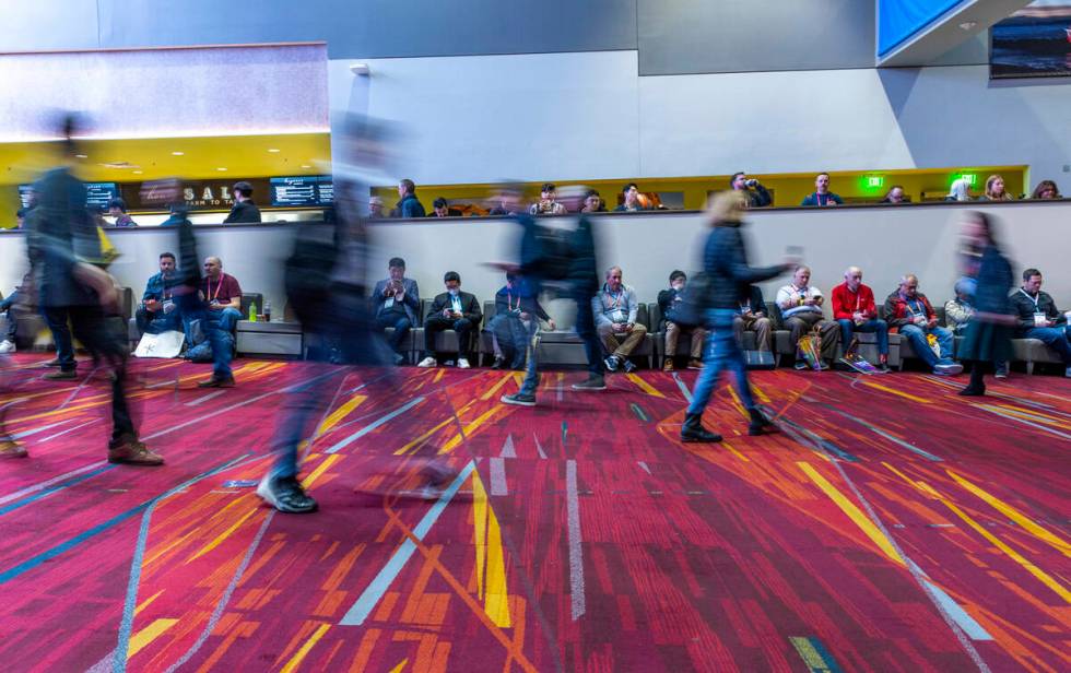 Attendees wander and rest between the north and central halls during the opening day of CES 202 ...