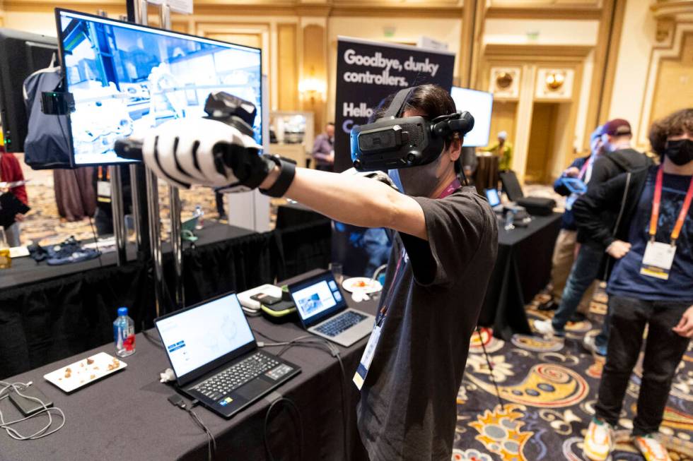 Yamato Sakoda gives a demonstration of the Diver-X virtual experience headset during the CES Sh ...