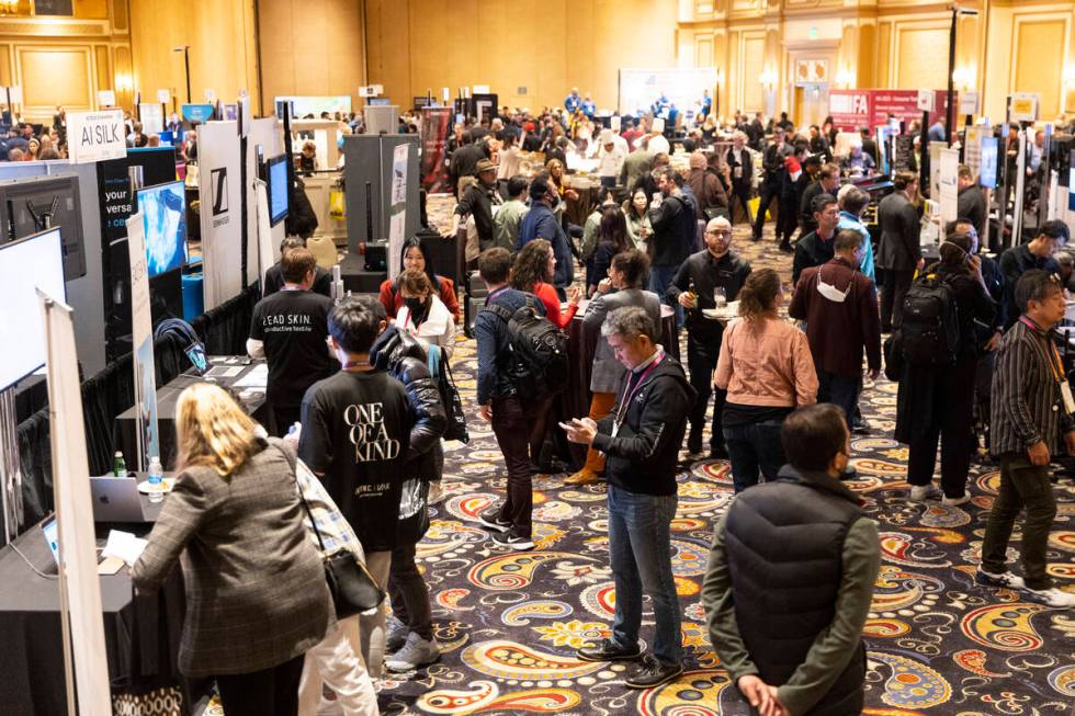 People attend CES ShowStoppers event at the Bellagio hotel-casino in Las Vegas, Thursday, Jan. ...