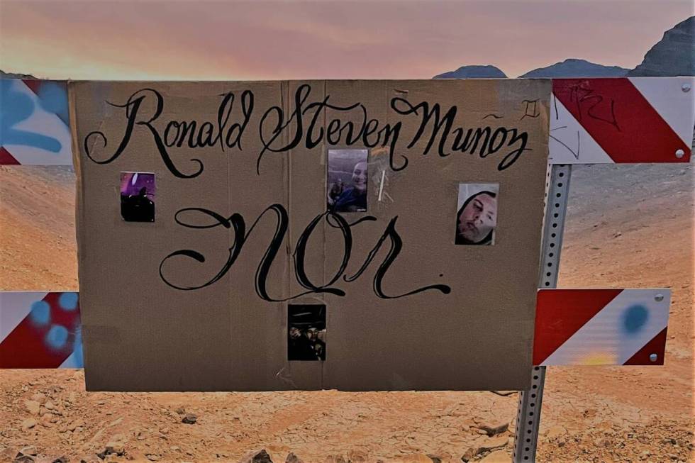 A cardboard sign in Summerlin marks the desert area where Ronald Munoz was found dead in 2021. ...