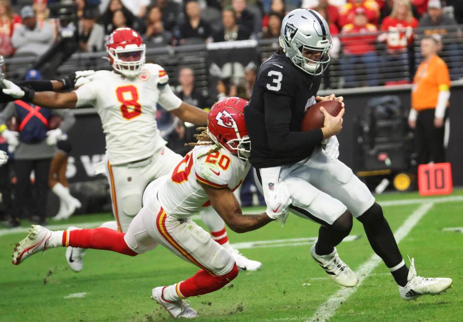 Raiders quarterback Jarrett Stidham (3) gets tackled by Kansas City Chiefs safety Justin Reid ( ...