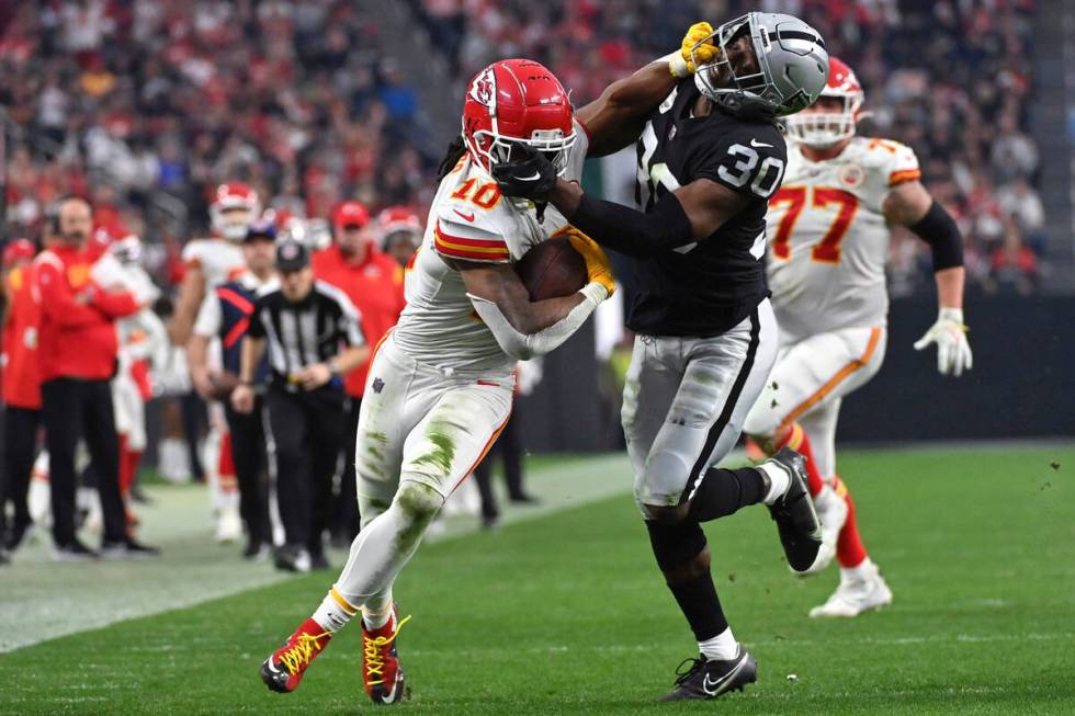 Kansas City Chiefs running back Isiah Pacheco (10) struggles for yardage as Las Vegas Raiders s ...