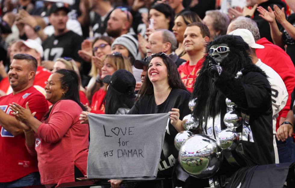 A Raiders fans holds up a sign in support of Buffalo Bills’ Damar Hamlin before an NFL g ...