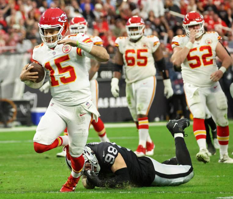 Kansas City Chiefs quarterback Patrick Mahomes (15) runs the ball past Raiders defensive end Ma ...