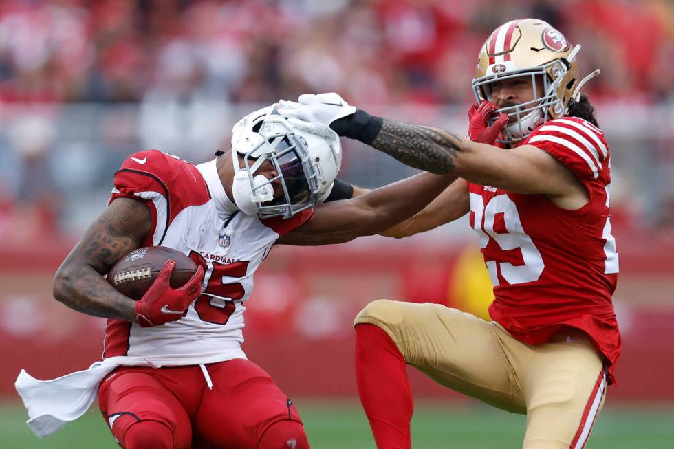 Arizona Cardinals wide receiver Pharoh Cooper, left, stiff arms San Francisco 49ers safety Tala ...