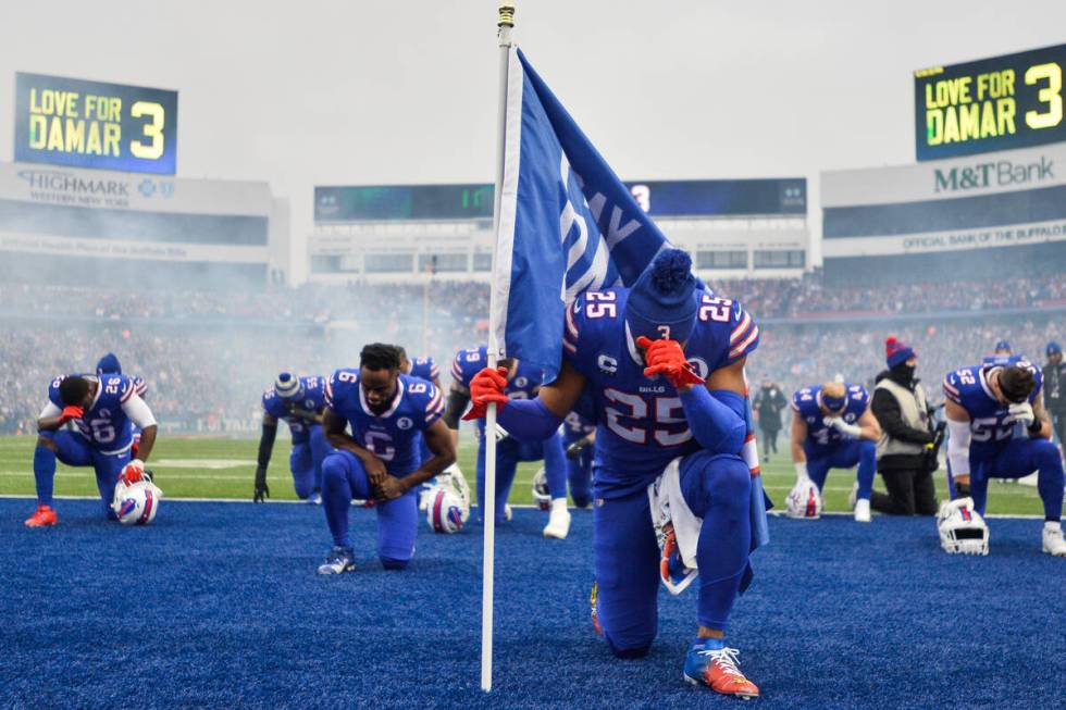 Buffalo Bills running back Taiwan Jones (25) kneels in prayer for safety Damar Hamlin before an ...