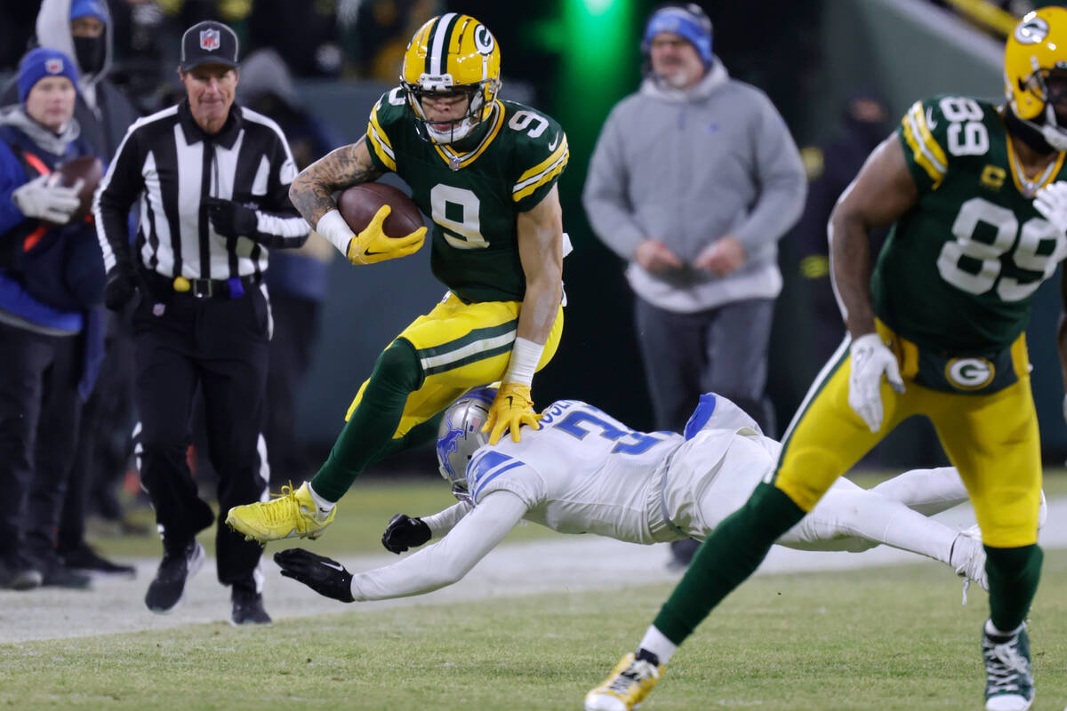 Green Bay Packers wide receiver Christian Watson (9) leaps over Detroit Lions safety Kerby Jose ...