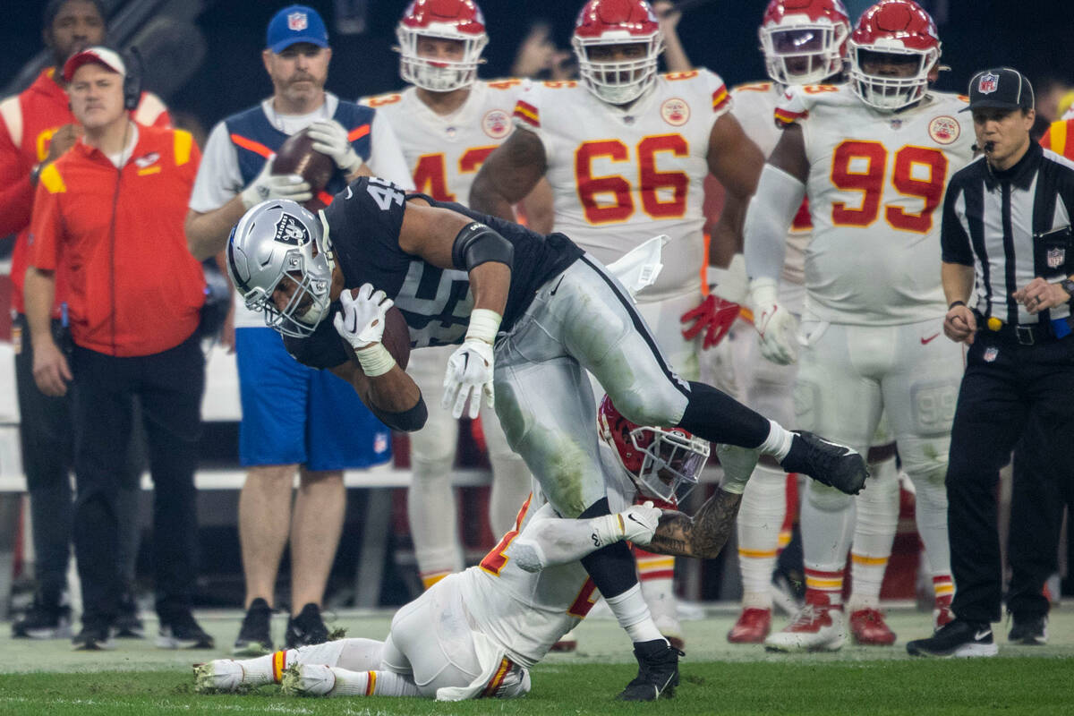 Raiders fullback Jakob Johnson (45) is tackled by Kansas City Chiefs cornerback Trent McDuffie ...