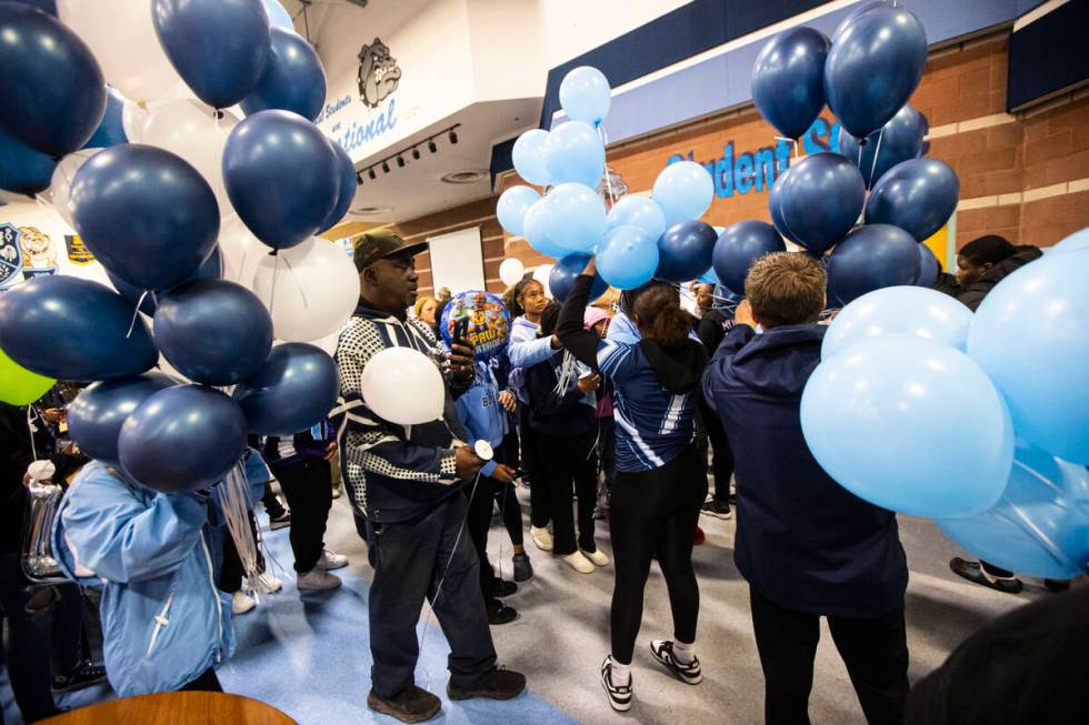 Balloons are handed out to friends and family of Ashari Hughes, 16, during a celebration of her ...