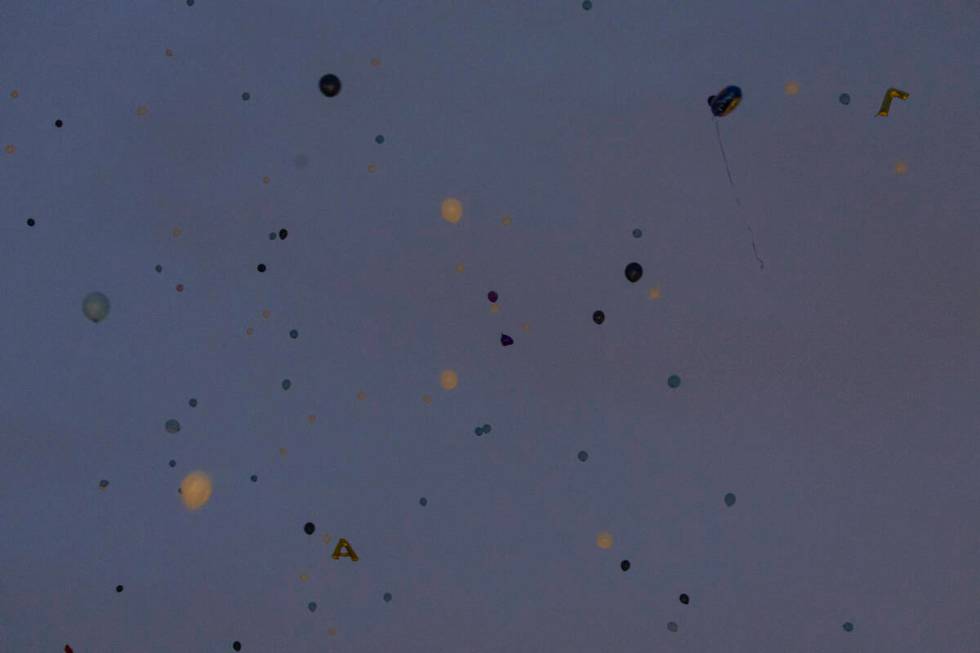 Balloons are released into the sky during a celebration of life in memory of Ashari Hughes, 16, ...