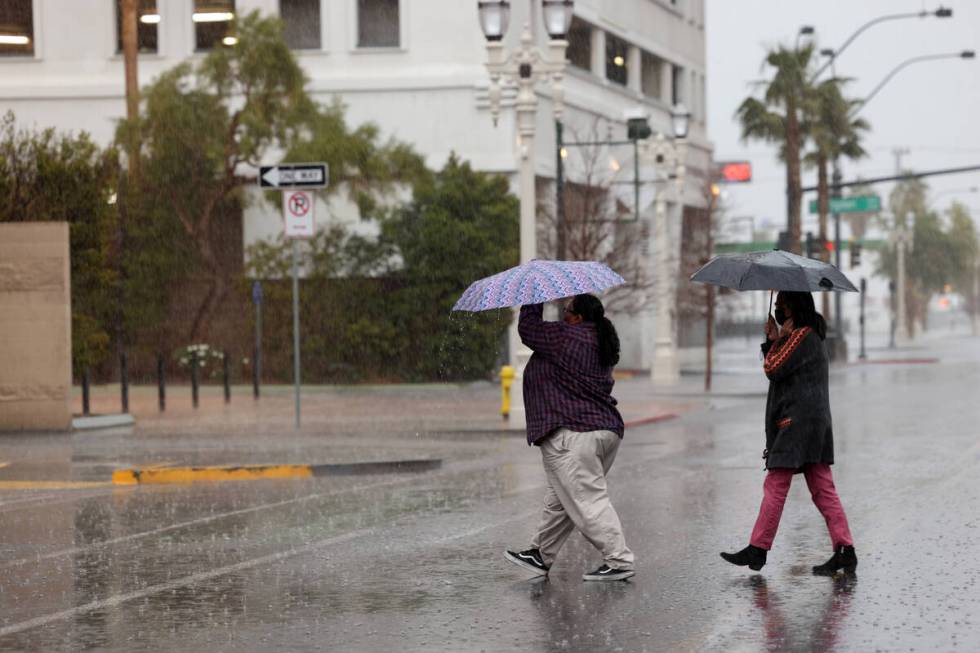 Pedestrians cross 6th Street near Fremont Street in Las Vegas Tuesday, Jan. 10, 2023. (K.M. Can ...