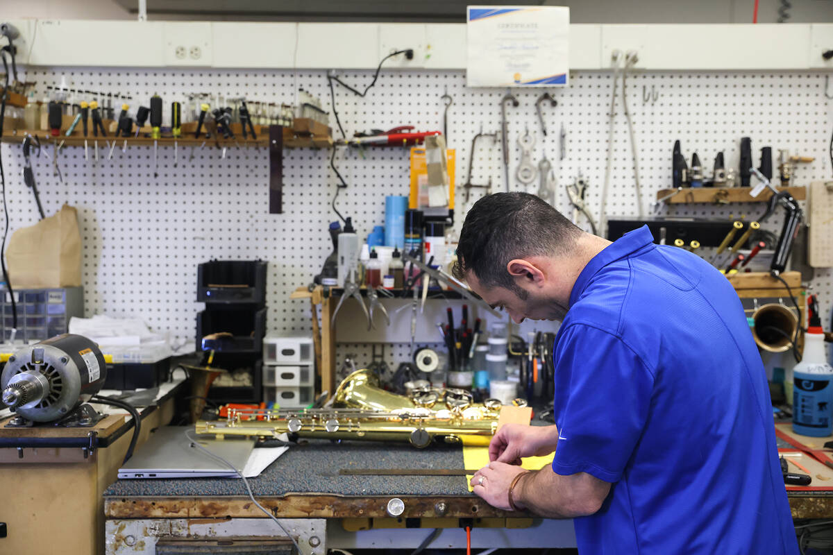 Tim Adelson, a musical instrument repair technician for the Clark County School District, repai ...