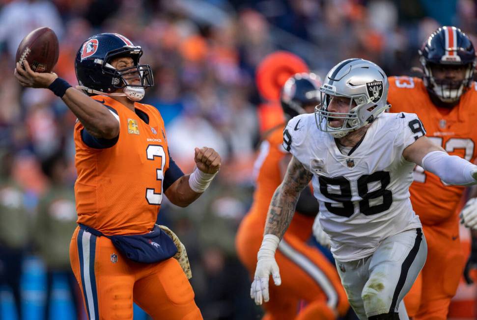 Raiders defensive end Maxx Crosby (98) pressures Denver Broncos quarterback Russell Wilson (3) ...