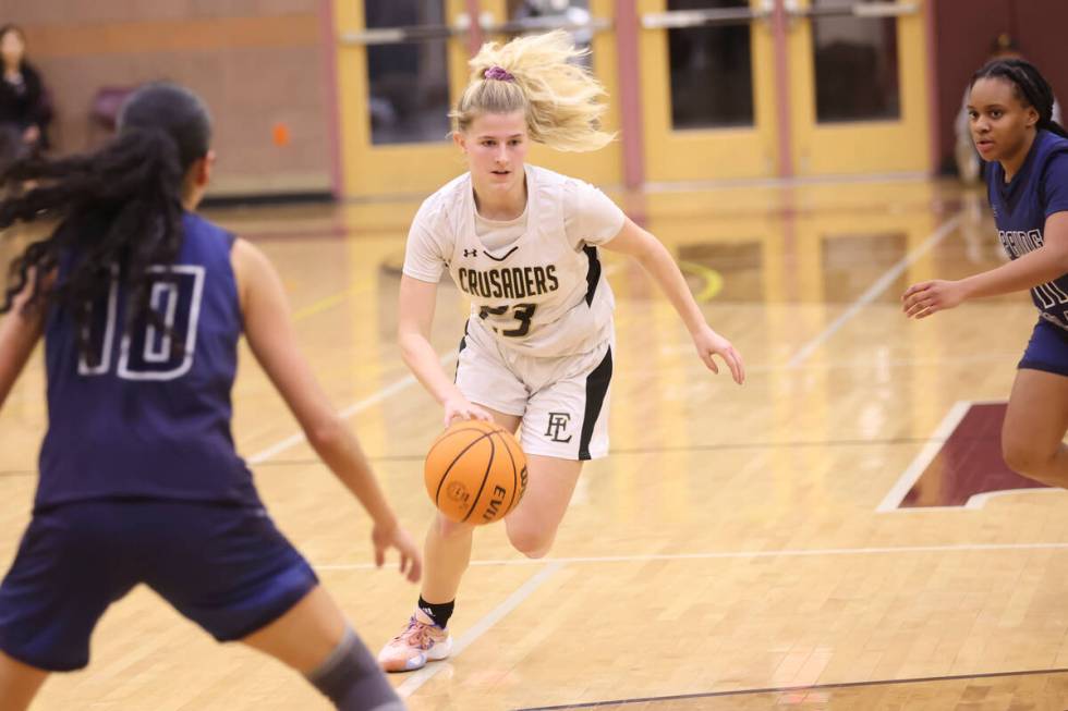 Faith Lutheran's Raina Forgue (23) drives to the basket against Spring Valley during the second ...