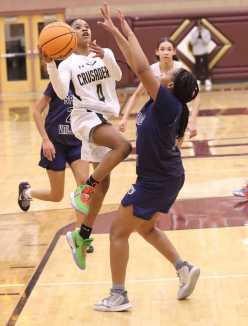 Faith Lutheran's Tamiah Harrison (4) shoots against Spring Valley's Mi'yana Stephens (11) durin ...