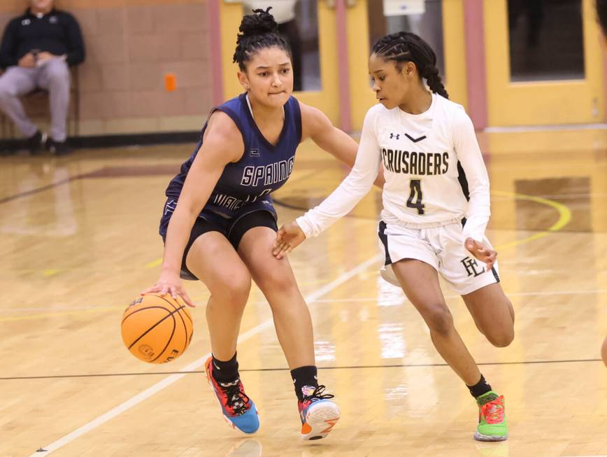 Spring Valley's Mia Ervin (1) brings the ball up court against Faith Lutheran's Tamiah Harrison ...