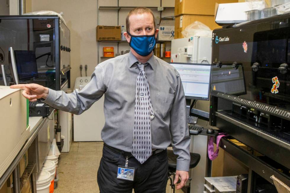 Dr. Mark Pandori, director of the Nevada State Public Health Lab, shows some of the technology ...