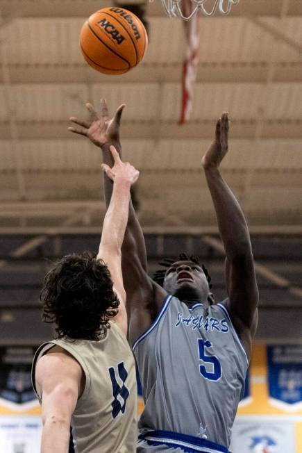 Desert Pines’ Greg Burrell (5) shoots against Foothill’s Zakary Abdalla (11) duri ...