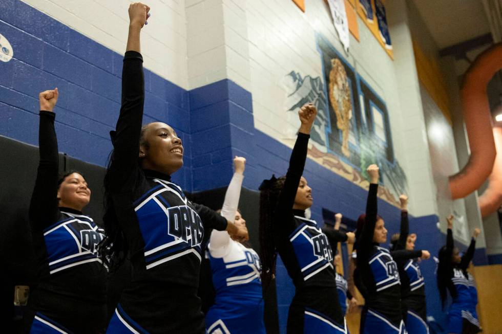 Desert Pines’ cheerleaders encourage their team during a boys high school basketball gam ...