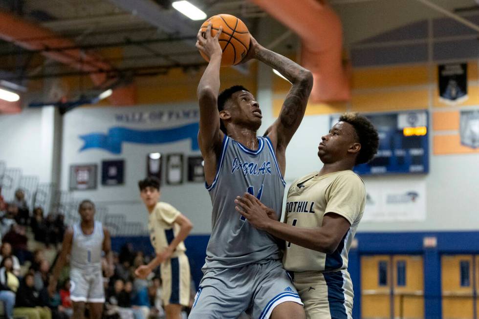 Desert Pines’ Evan Tatum (11) attempts to pass against Foothill’s Justin Brulee ( ...