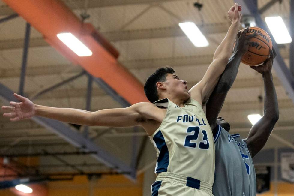 Foothill’s Shawn Salazar (23) attempts to block a shot by Desert Pines’ Greg Burr ...