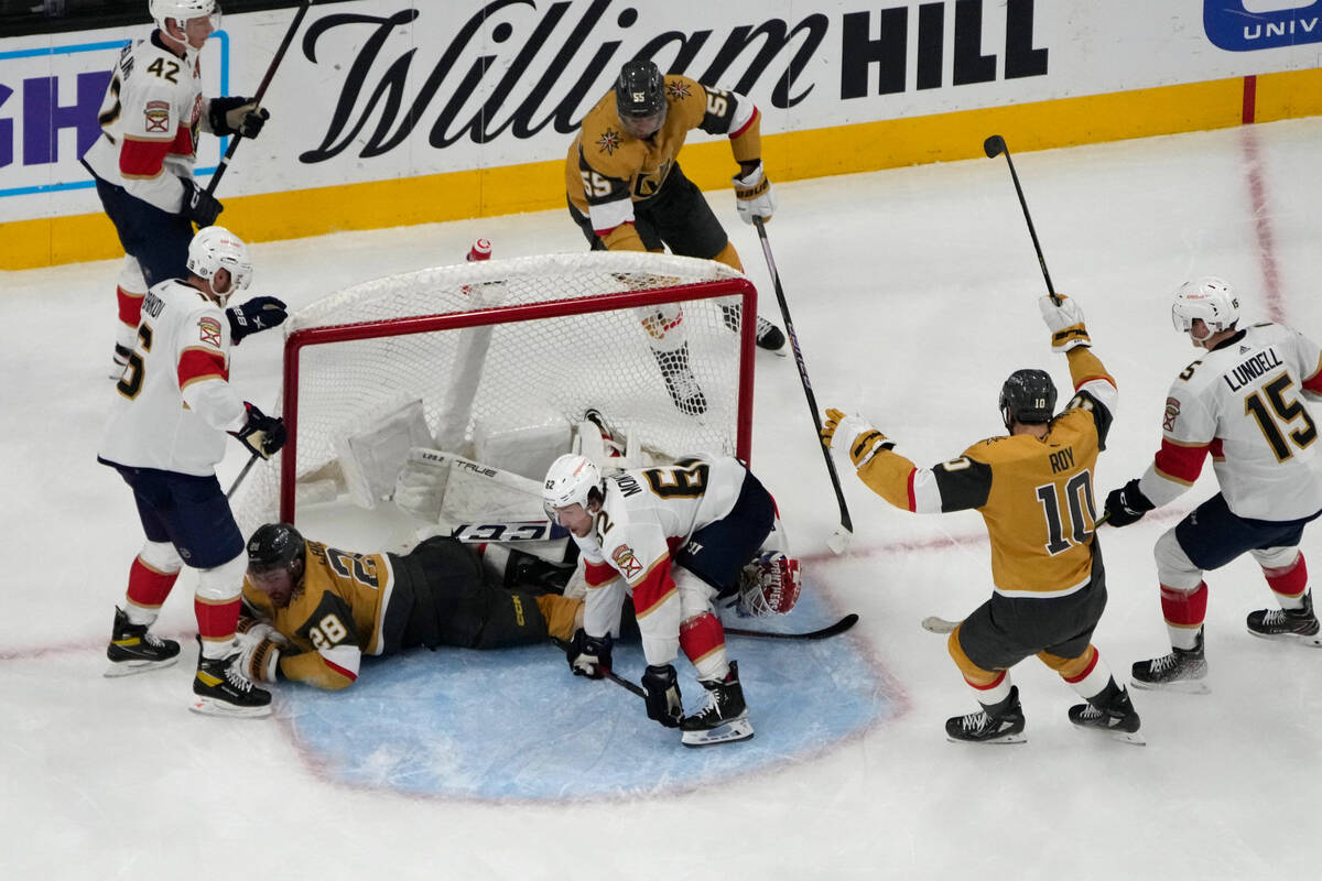 Vegas Golden Knights center Nicolas Roy (10) and right wing Keegan Kolesar (55) celebrate after ...