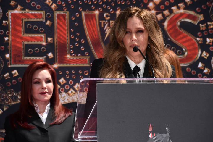 Priscilla Presley, former wife of the late singer Elvis Presley, left, looks on as her daughter ...