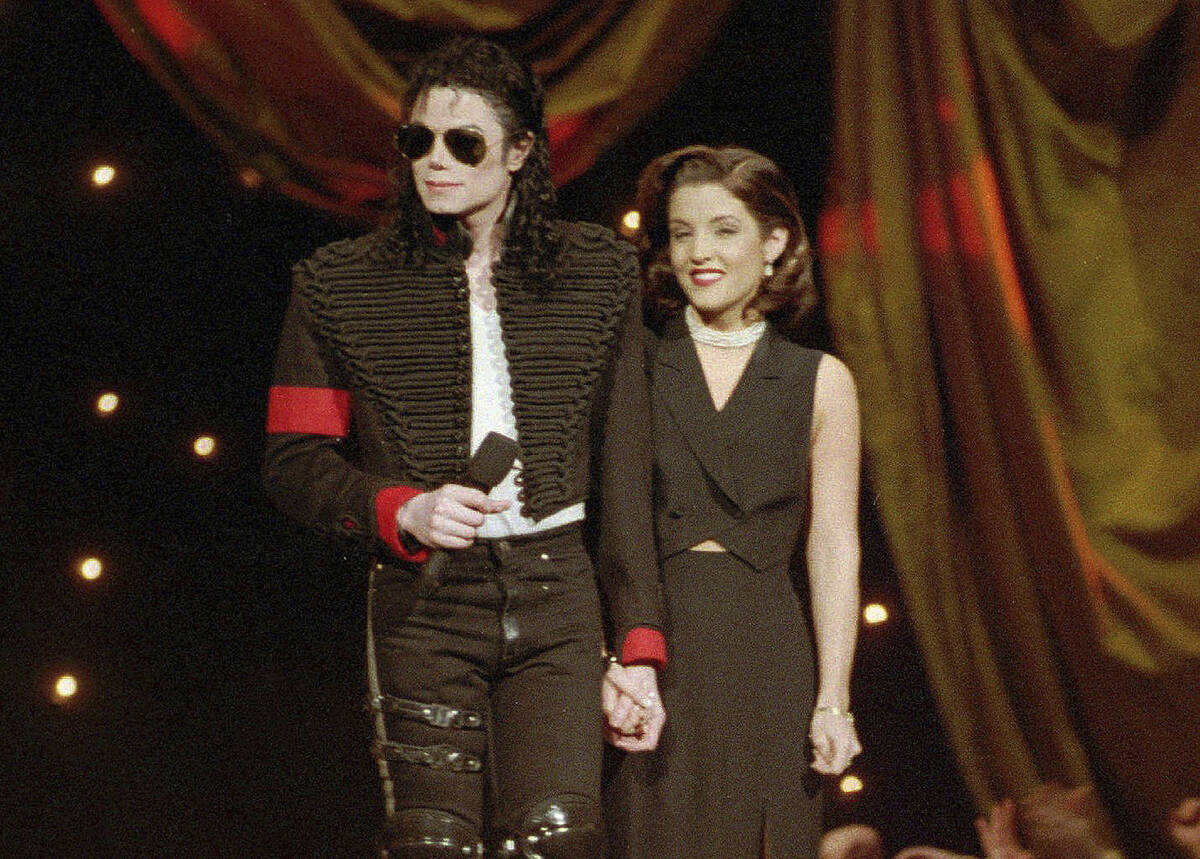 Michael Jackson and Lisa Marie Presley-Jackson acknowledge applause from the audience after com ...