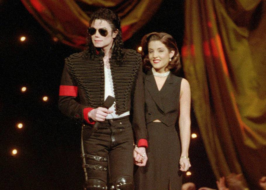 Michael Jackson and Lisa Marie Presley-Jackson acknowledge applause from the audience after com ...