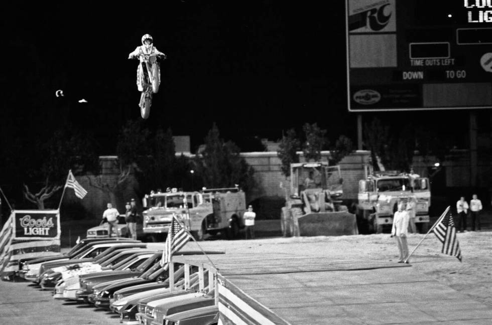 Robbie Knievel jumps his motorcycle 153 1/2 feet over 22 parked cars in May 1987 at Sam Boyd St ...