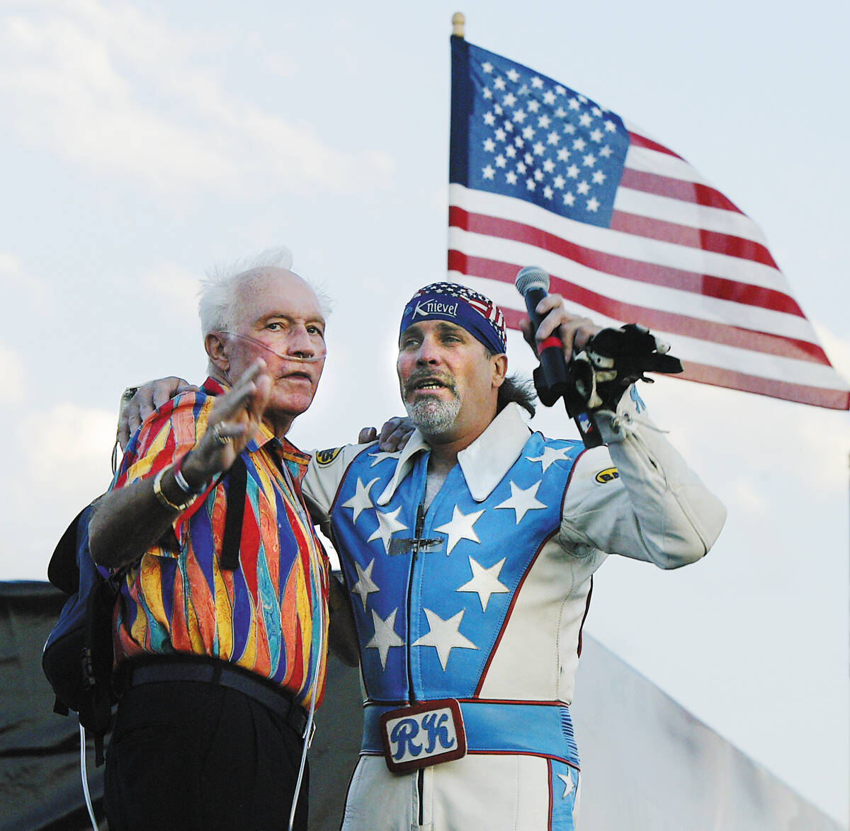 Daredevil Evel Knievel and his son and fellow daredevil Robbie Knievel embrace at the top of th ...
