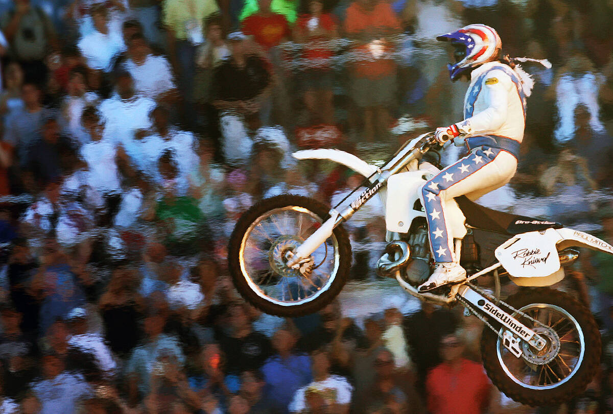 Heat from pyrotechnics creates a heat wave effect as motorcycle stunt rider Robbie Knievel succ ...