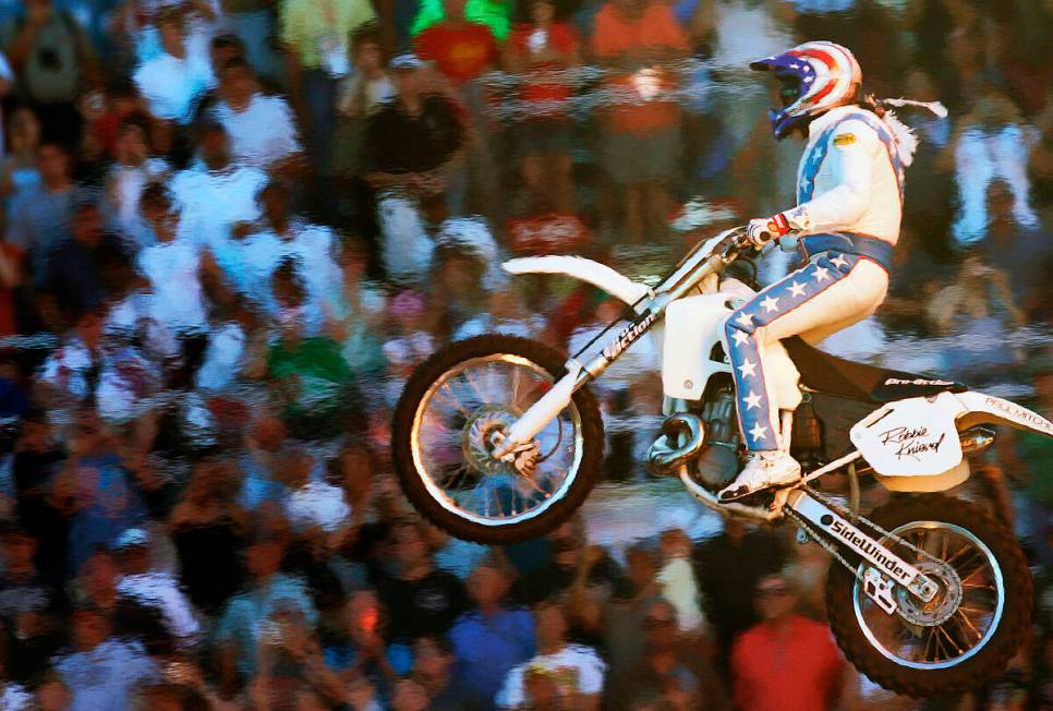 Heat from pyrotechnics creates a heat wave effect as motorcycle stunt rider Robbie Knievel succ ...