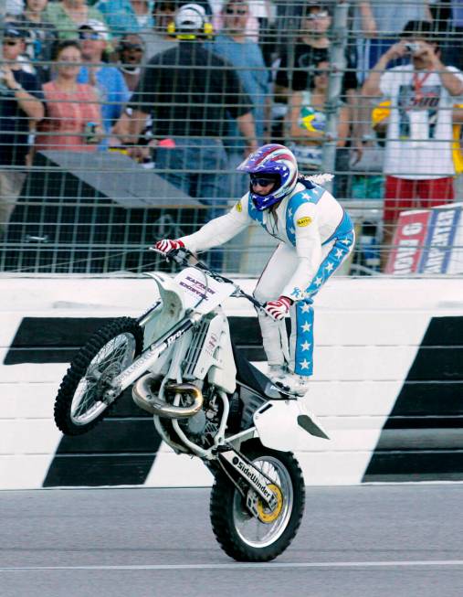 Stunt motorcycle driver Robbie Knievel performs a stunt for fans prior to making his jump over ...