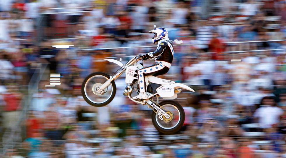 Kaptain Robbie Knievel flies on his motorcycle for a jump before the start of the IRL Firestone ...