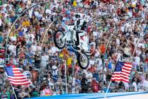 Kaptain Robbie Knievel lands a motorcycle jump before the start of the IRL Firestone 550 auto r ...