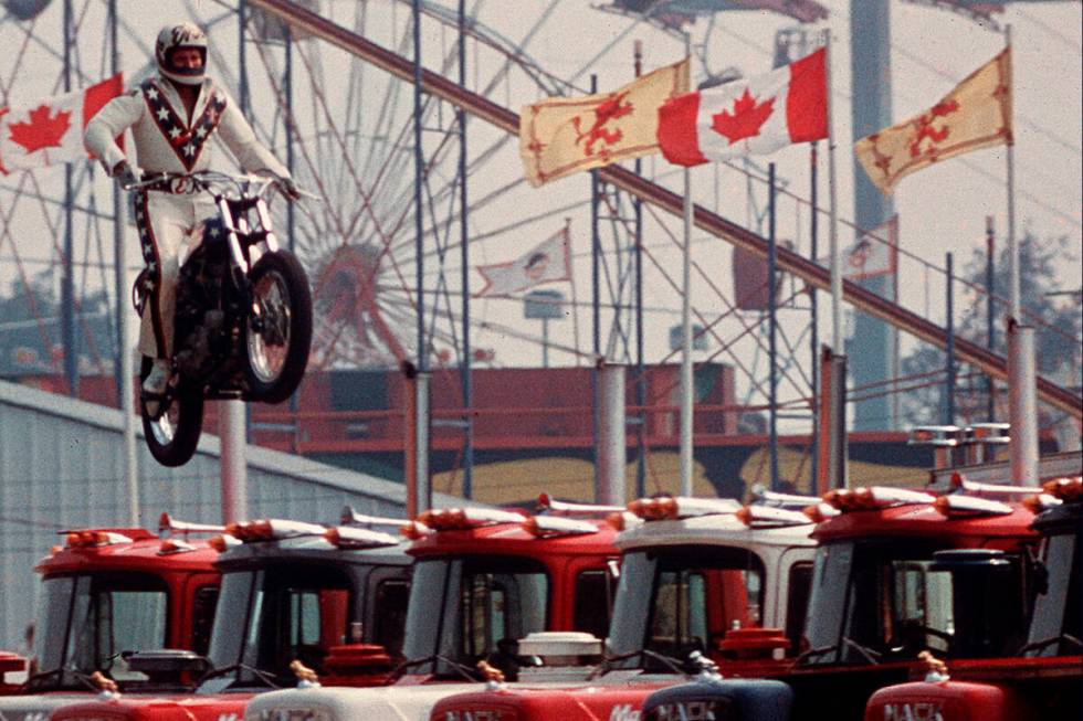 In this Aug. 20, 1974, file photo daredevil motorcyclist Evel Knievel sails over 7 Mack trucks ...